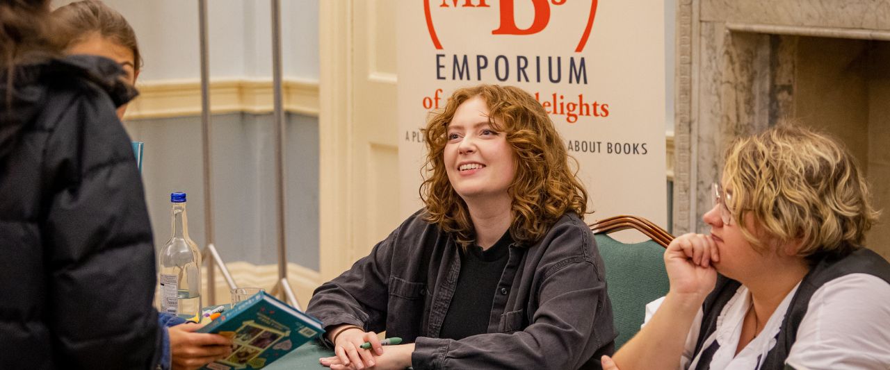 Author Alice Oseman signing books