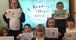 School children and their drawings watching a Reading is Magic Festival event