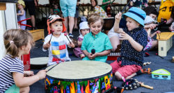 A group of small children playing with musical instruments