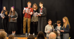 Young writers performing onstage