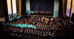 The full schools' voices choir onstage at The Forum along with the full orchestra from Bath Philharmonia.