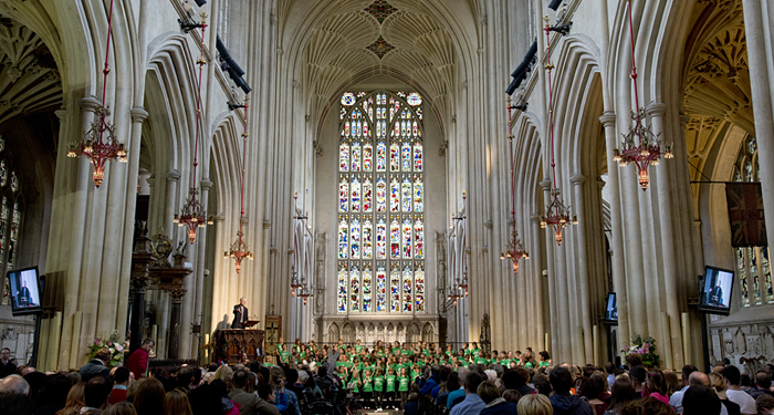 A choir of school children performing inside Bath Abbey
