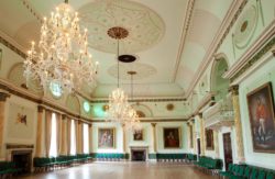 The Banqueting Room at the Guildhall. It is a large decorative room with 3 chandeliers hanging from the ceiling
