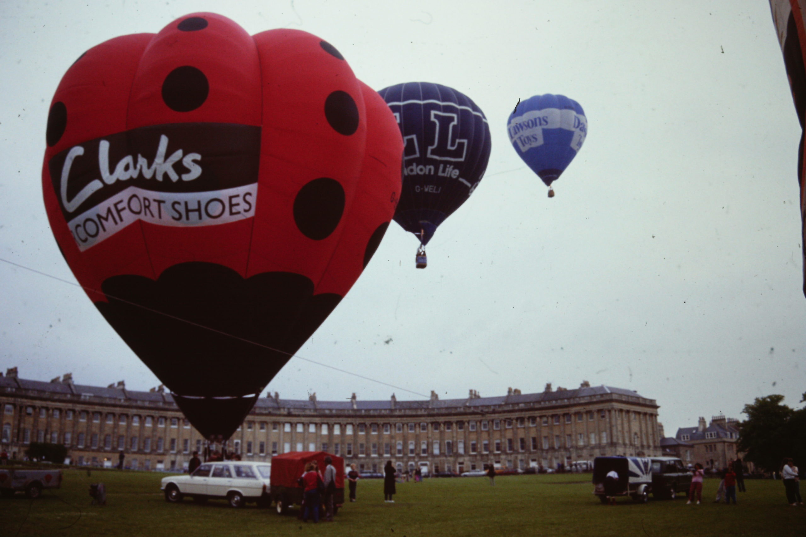 Three hot air balloons taking off outside the Royal Crescent