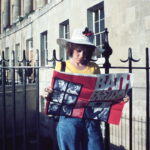 A lady stood in front of the Royal Crescent reading a Bath Festival programme from 1974