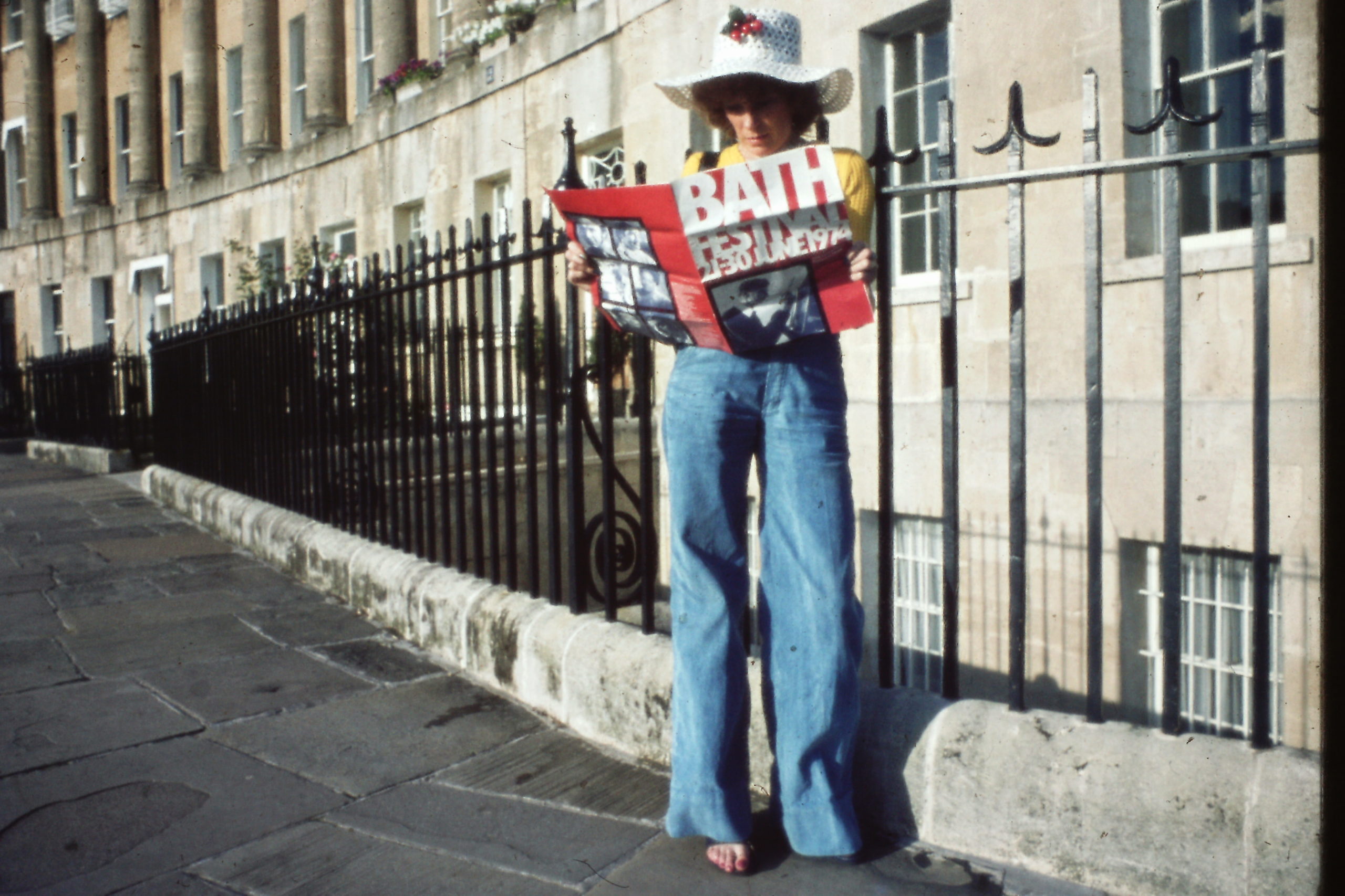 Lady stood outside the Royal Crescent reading a Bath Festival programme from 1974