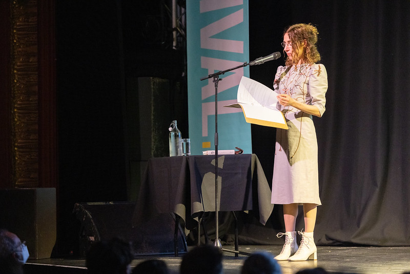PJ Harvey reading onstage at Komedia